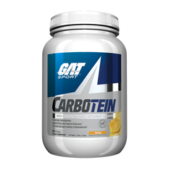 A white plastic tub of GAT Sport Carbotein supplement powder with a blue, white, and silver label, featuring an orange slice graphic on the right side indicating the Orange flavor.