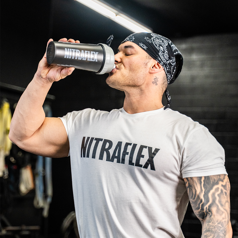 Picture of Jeremy Buendia in a gym drinking Nitraflex pre-workout