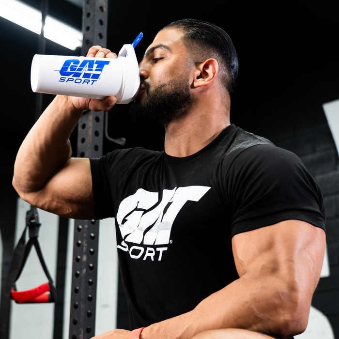 Workout recovery, fitness athlete drinking from a GAT Sport shaker cup